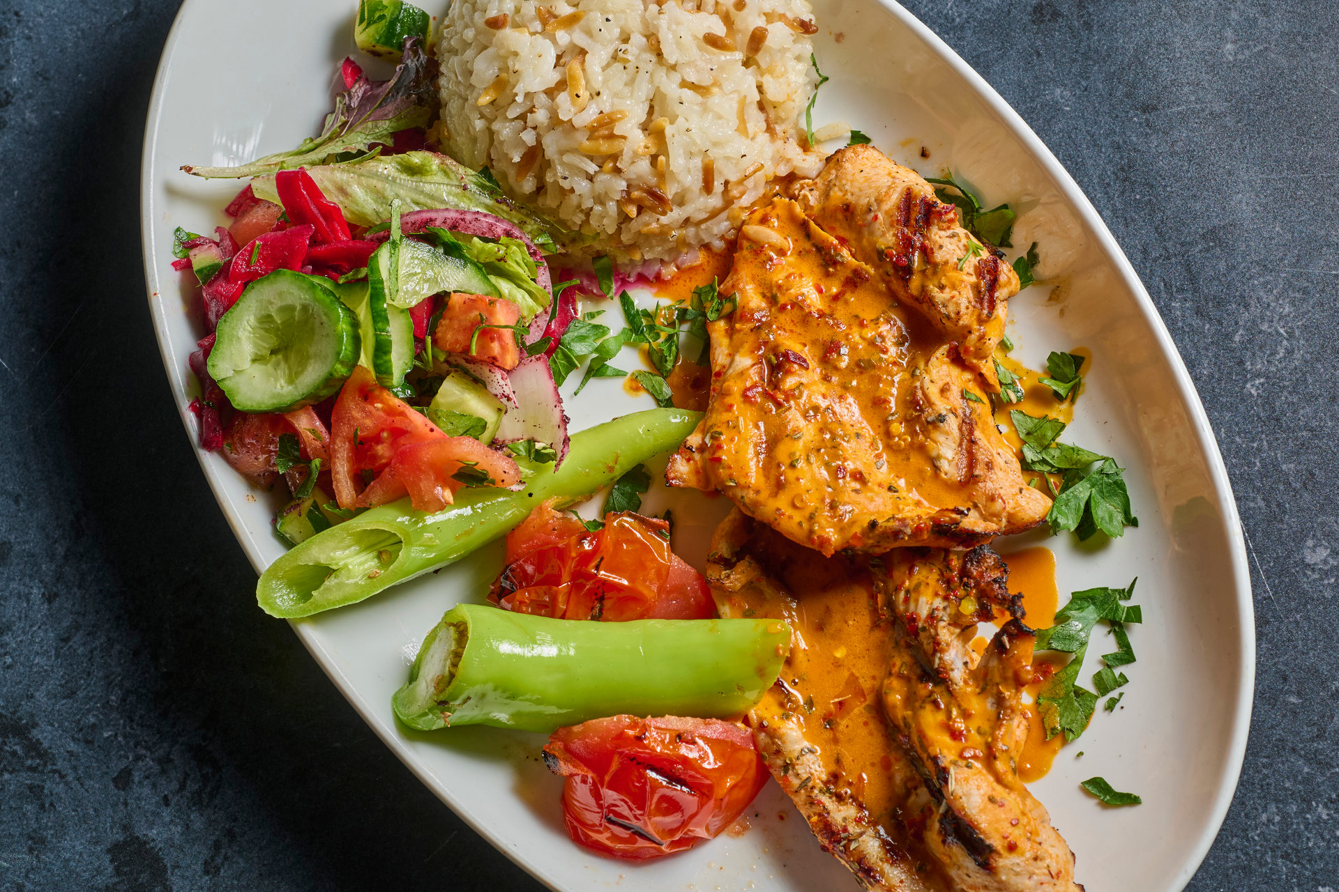 Grilled chicken fillet with rice, salad and grilled peppers