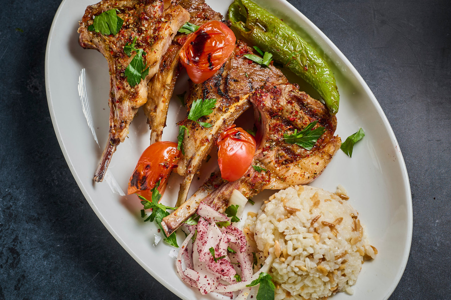 Lamb cutlets with grilled tomato, pepper and rice
