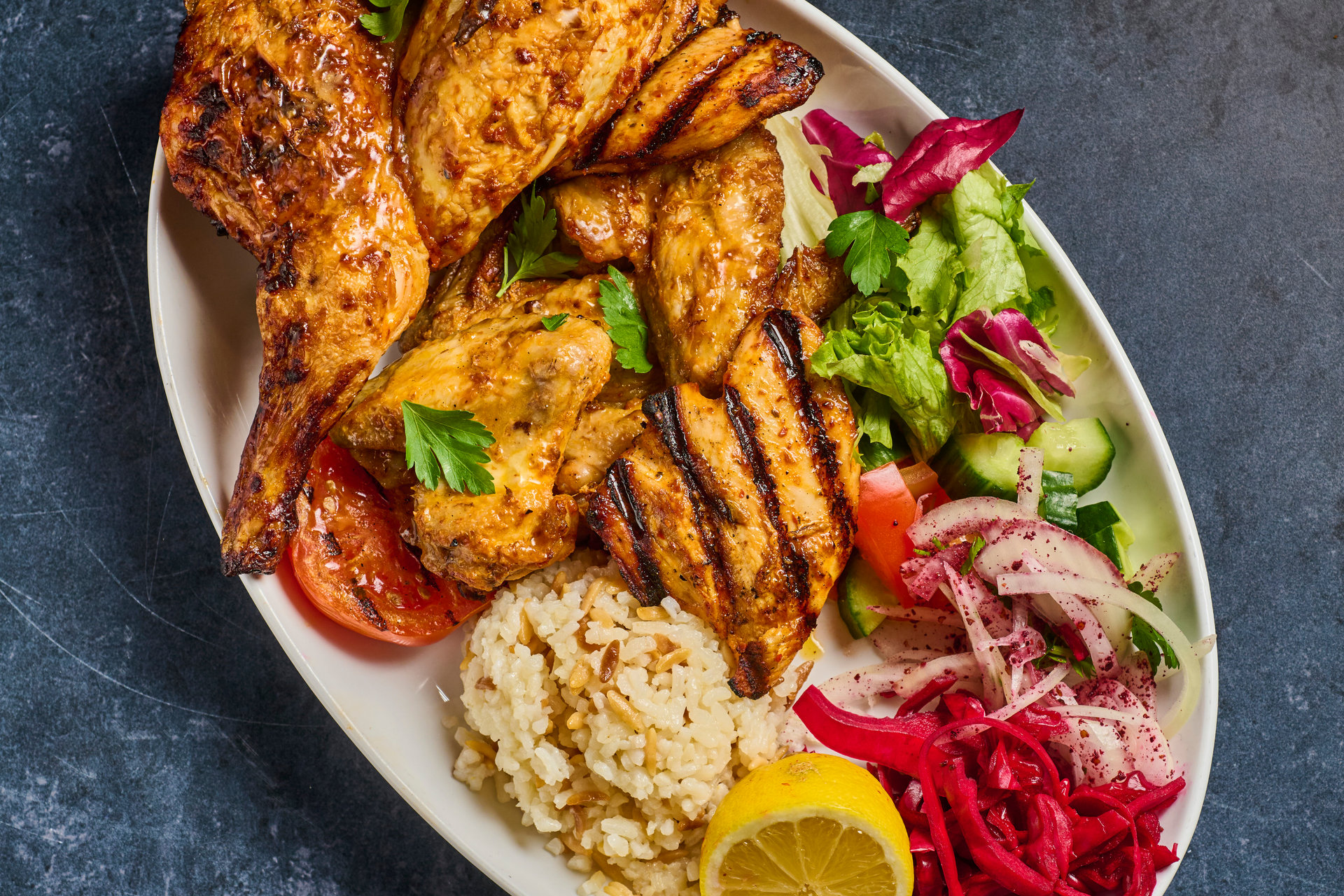 Mixed chicken grill with wings, rice and salad